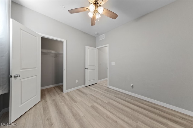 unfurnished bedroom with visible vents, baseboards, ceiling fan, light wood-type flooring, and a closet