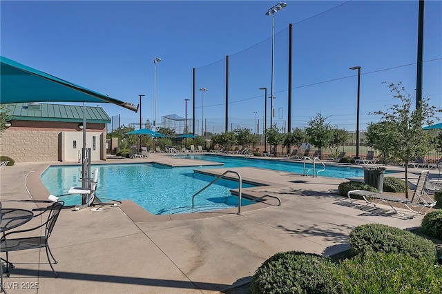 pool featuring fence and a patio