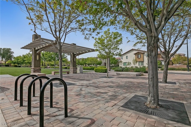 view of home's community featuring a yard and a pergola