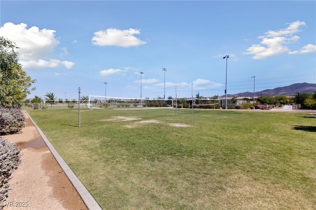 view of home's community with volleyball court and a mountain view