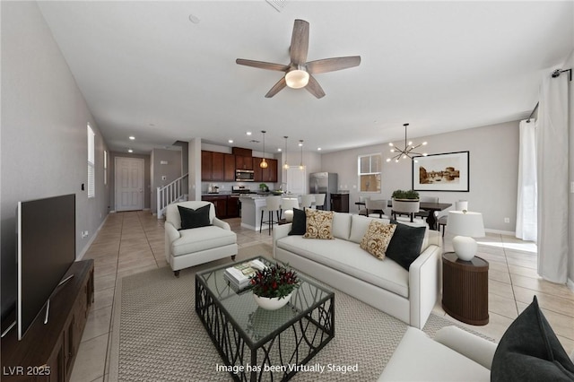 living room featuring recessed lighting, stairs, ceiling fan with notable chandelier, and light tile patterned flooring