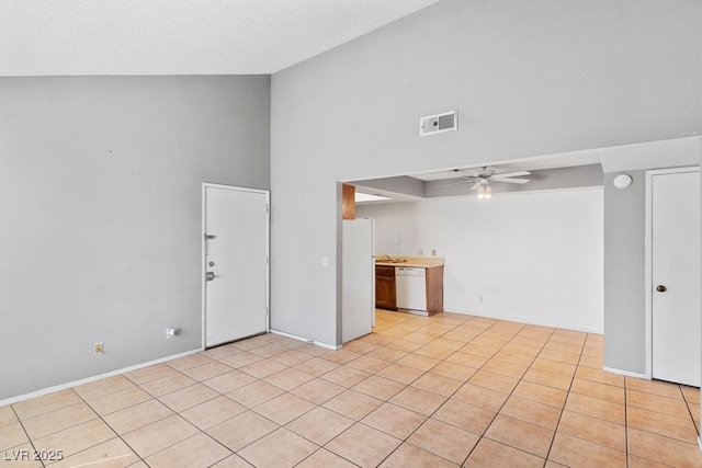 interior space with high vaulted ceiling, visible vents, ceiling fan, and light tile patterned flooring