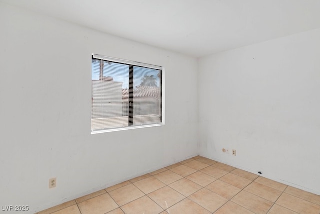 unfurnished room with light tile patterned floors