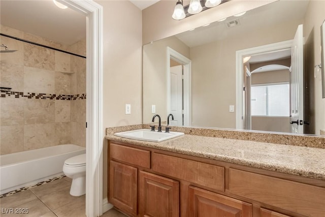 bathroom featuring tile patterned flooring, toilet, vanity, visible vents, and  shower combination