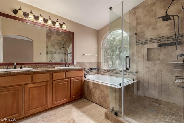 bathroom featuring a garden tub, a sink, a shower stall, and double vanity