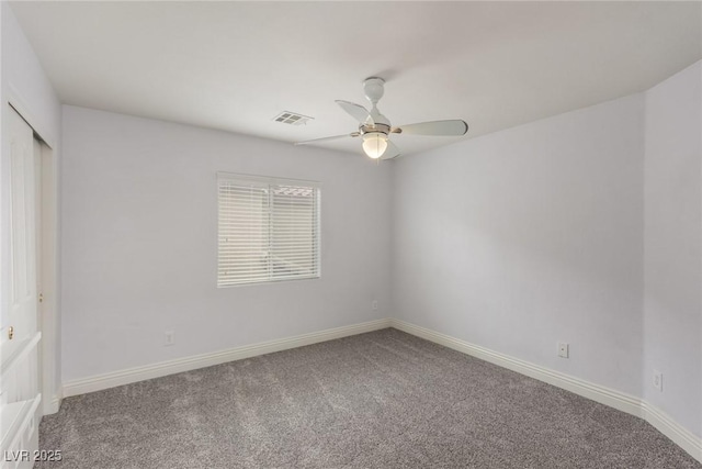 empty room featuring ceiling fan, carpet flooring, visible vents, and baseboards