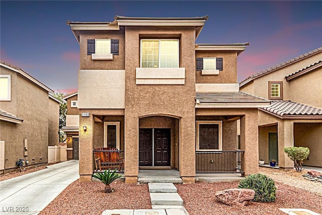 view of front of home with a porch and stucco siding