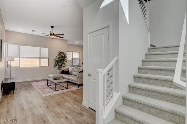 staircase with visible vents, baseboards, ceiling fan, wood finished floors, and recessed lighting