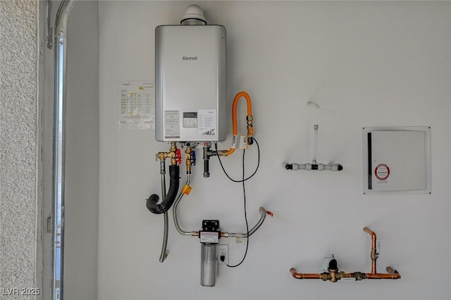 utility room with tankless water heater