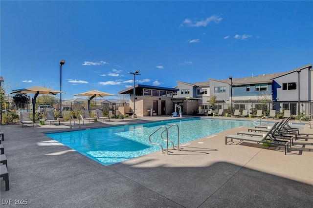 pool featuring fence and a patio