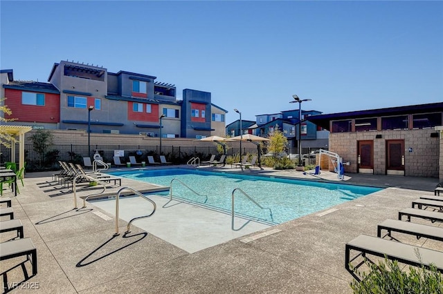 pool featuring a residential view, fence, and a patio