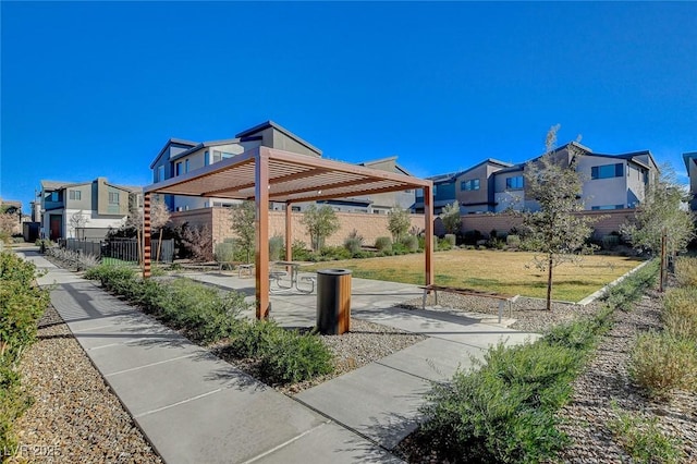 surrounding community featuring a residential view, a pergola, fence, and a patio