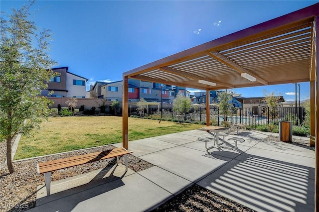 view of patio / terrace with a residential view, fence, and a pergola