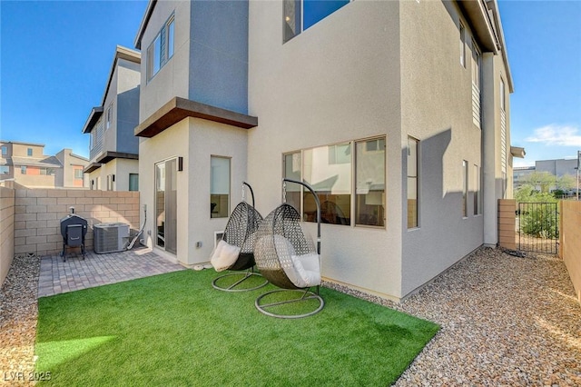 back of property featuring cooling unit, a patio area, a fenced backyard, and stucco siding