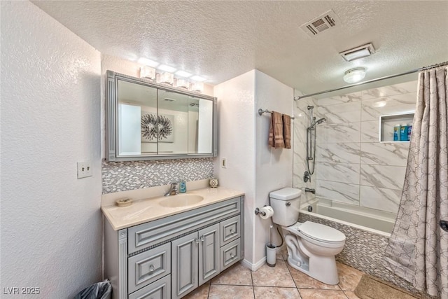 bathroom featuring visible vents, toilet, a textured ceiling, tiled shower / bath combo, and vanity