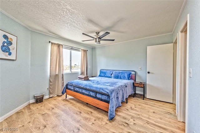 bedroom featuring a textured ceiling, wood finished floors, crown molding, ceiling fan, and a textured wall