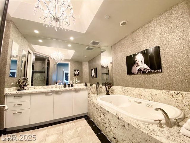 bathroom with visible vents, a garden tub, vanity, a chandelier, and recessed lighting