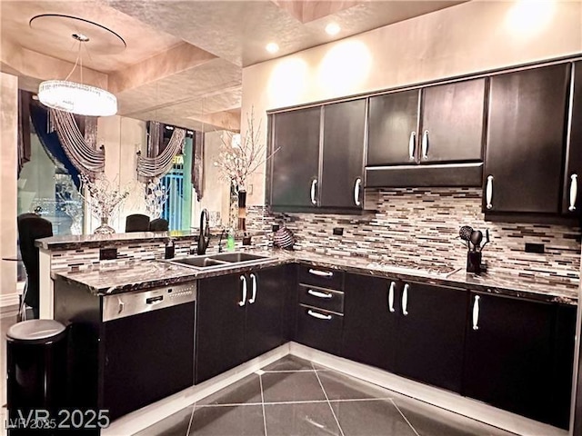 kitchen with black dishwasher, pendant lighting, tasteful backsplash, a sink, and a peninsula