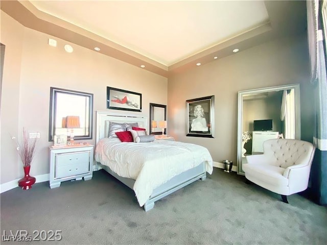 carpeted bedroom featuring a tray ceiling, recessed lighting, and baseboards