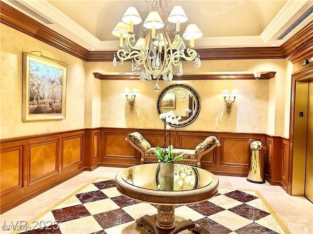 unfurnished room with visible vents, ornamental molding, a notable chandelier, and wainscoting