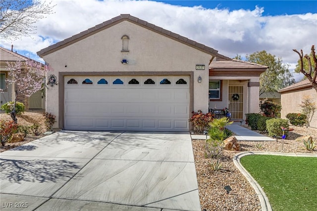 single story home featuring concrete driveway, a tiled roof, an attached garage, and stucco siding