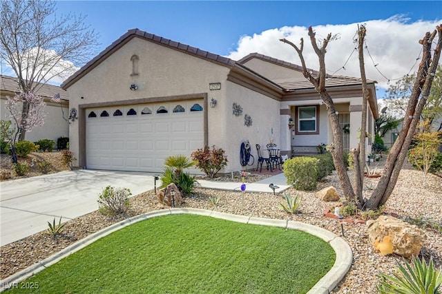 view of front of home featuring a garage, driveway, a tile roof, and stucco siding