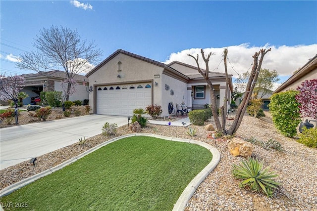 ranch-style home with stucco siding, concrete driveway, an attached garage, a front yard, and a tiled roof