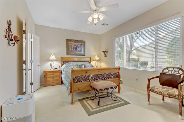 bedroom featuring a ceiling fan, carpet, visible vents, and baseboards