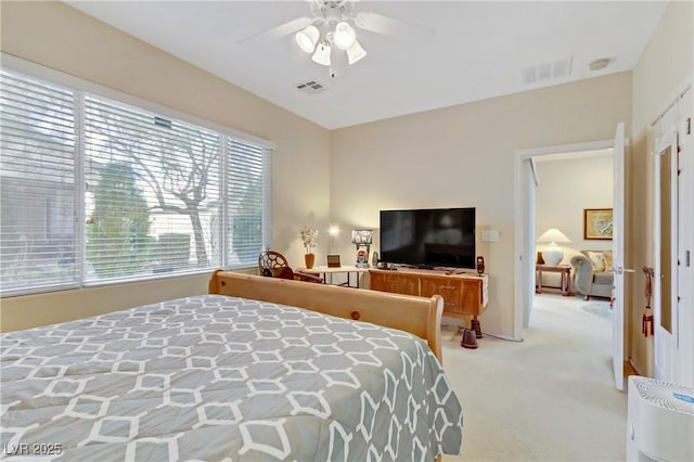 bedroom featuring a ceiling fan, light colored carpet, and visible vents