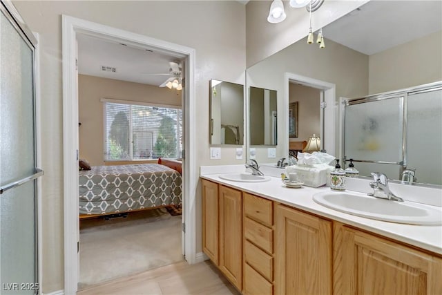 ensuite bathroom with a sink, ceiling fan, and ensuite bath