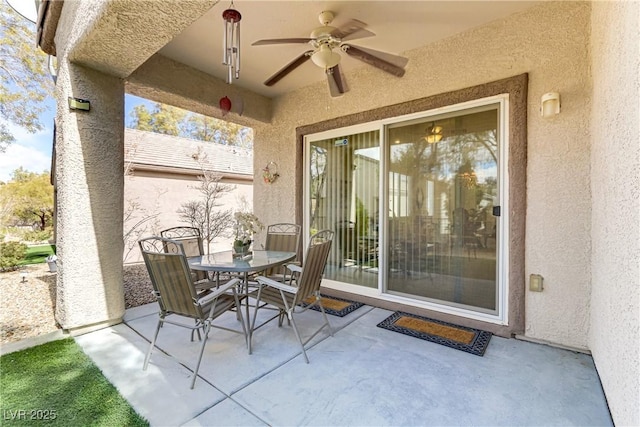 view of patio / terrace with outdoor dining area and a ceiling fan