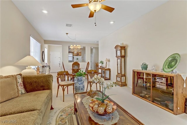 living area with recessed lighting, carpet, visible vents, and ceiling fan with notable chandelier