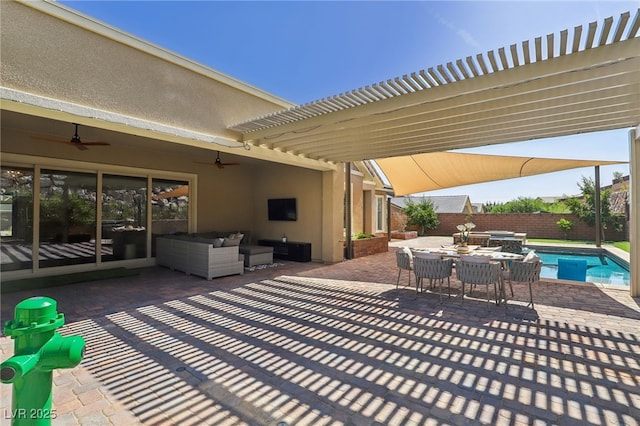 view of patio / terrace with outdoor dining area, a pool with connected hot tub, a ceiling fan, a fenced backyard, and an outdoor living space