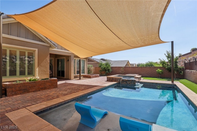 view of pool with a patio area, a fenced backyard, and a pool with connected hot tub