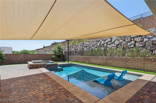 view of swimming pool with a patio area, a fenced backyard, and a pool with connected hot tub