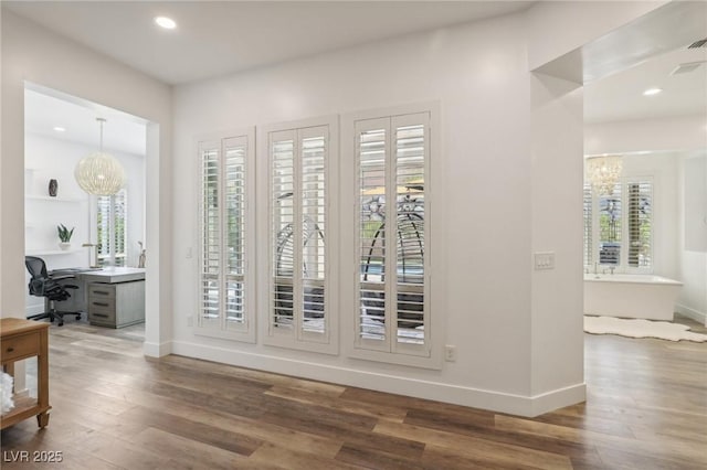 entryway with baseboards, wood finished floors, and recessed lighting