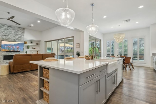 kitchen featuring gray cabinets, light countertops, visible vents, a sink, and white dishwasher