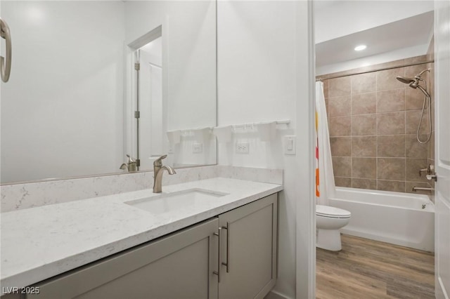 full bath featuring toilet, shower / bath combination with curtain, wood finished floors, and vanity