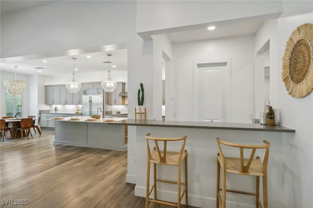 kitchen with gray cabinets, built in fridge, dark wood finished floors, and recessed lighting