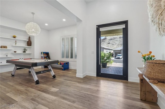 foyer entrance with a chandelier, recessed lighting, wood finished floors, and baseboards