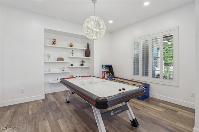 recreation room with built in features, recessed lighting, wood finished floors, a chandelier, and baseboards