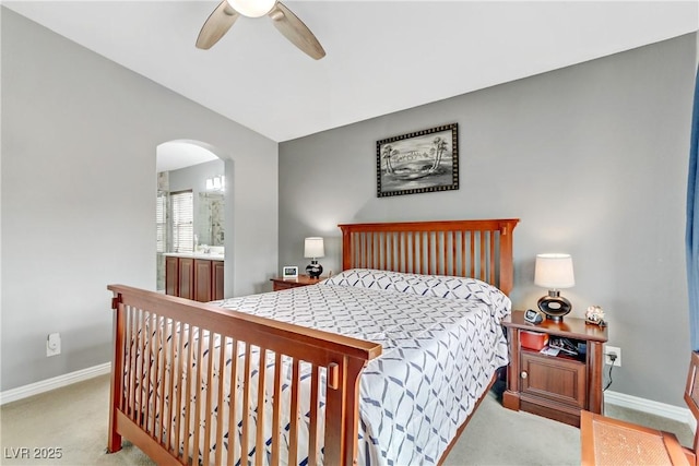 bedroom featuring arched walkways, carpet, lofted ceiling, and baseboards