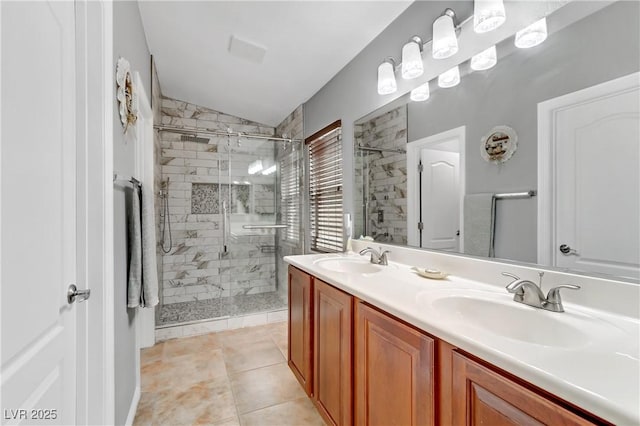 bathroom with lofted ceiling, a shower stall, double vanity, and a sink