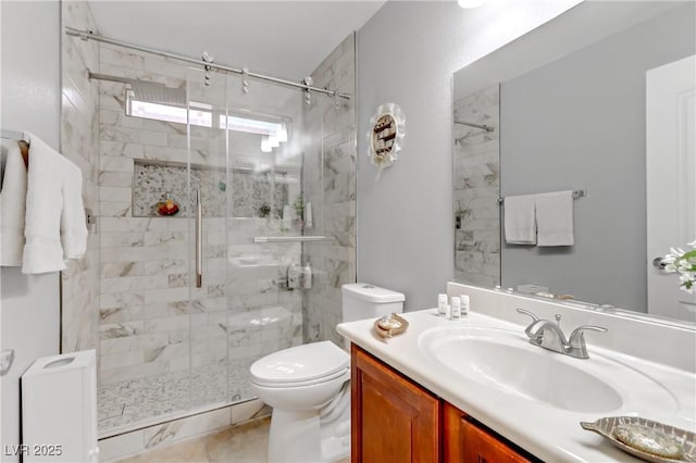 full bathroom featuring a stall shower, vanity, and toilet