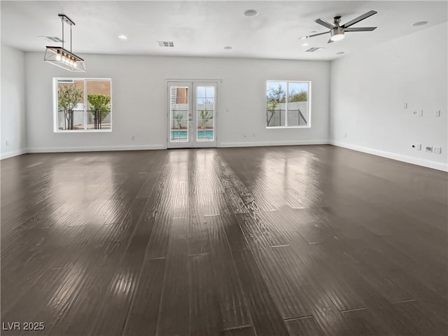 unfurnished living room with french doors, baseboards, wood finished floors, and a ceiling fan