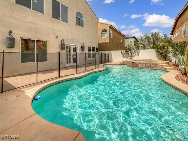 view of swimming pool featuring a fenced in pool, a fenced backyard, french doors, and a patio area