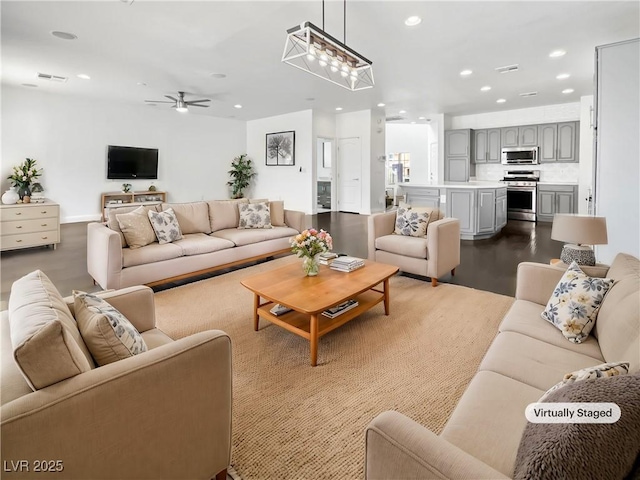 living area featuring a ceiling fan, recessed lighting, and visible vents