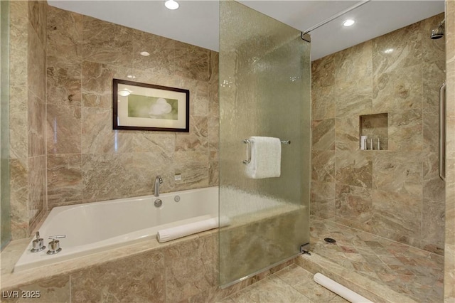 bathroom with tiled bath, recessed lighting, tile walls, a tile shower, and tile patterned floors