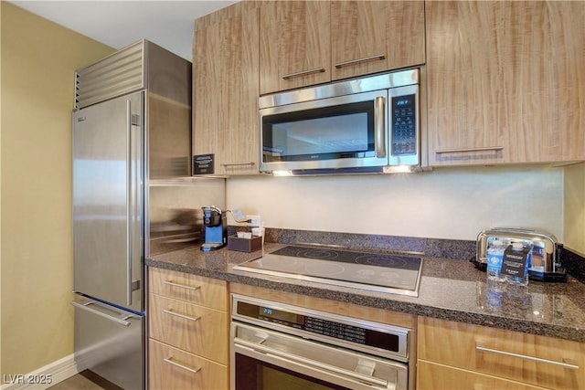 kitchen with light brown cabinets, modern cabinets, and stainless steel appliances