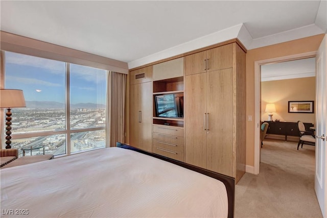 bedroom with crown molding, a closet, light colored carpet, visible vents, and baseboards